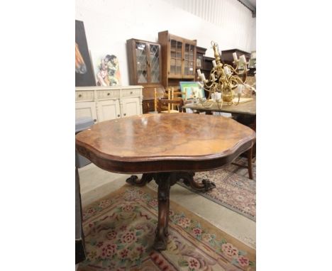 Victorian Walnut Veneered Circular Dining Table with shaped edge raised on a heavily carved tripod base