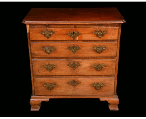 A George II mahogany bachelors chest, moulded top with re-entrant angles, above a slide and four long graduated drawers, pier