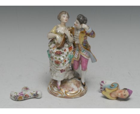 A late 19th century German porcelain figure group, of a courting couple in 18th century dress, dancing to the music of a lute