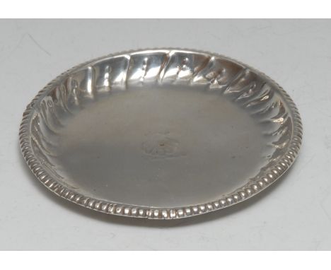 A George III Irish silver circular counter dish, fluted border, crested, 10cm diam, probably Thomas Jones, Dublin c.1780