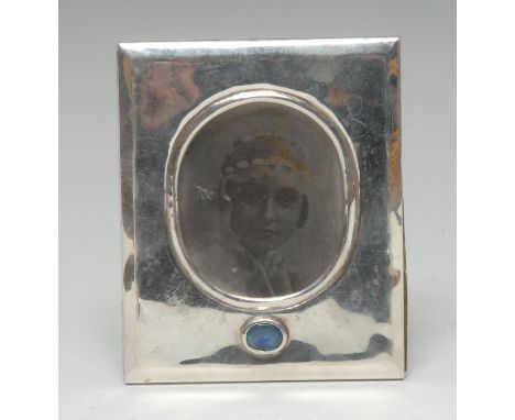 An Australian Arts and Crafts style silver rectangular easel photograph frame, oval aperture above an opalescent cabochon, Pa