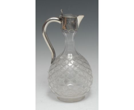 A Victorian silver mounted clear glass globular claret jug, parcel-etched with a field of star-motifs, hinged cover with 'Ons