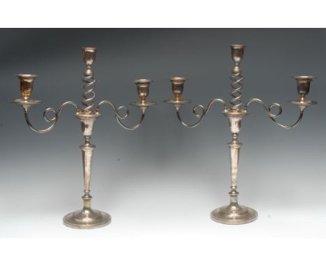 A pair of George III Old Sheffield plate three-light table candelabra, urnular sconces, open-twist branches, tapered pillars,