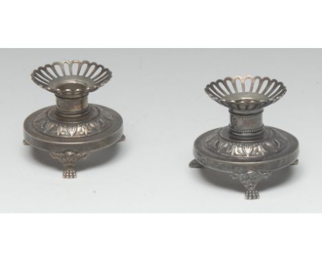 A pair of French silver desk top candlesticks, pierced sconces, domed circular bases chased with bands of stiff leaves, lion 