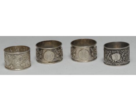 A collection of Chinese silver napkin rings, various designs and makers (4)