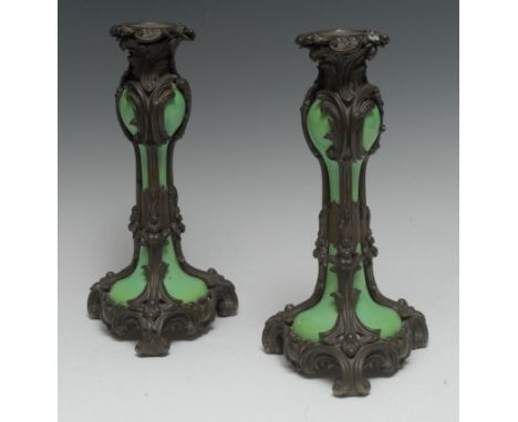 A pair of 19th century Rococo Revival bronze and apple green porcelain candlesticks, cast throughout with scrolling acanthus,