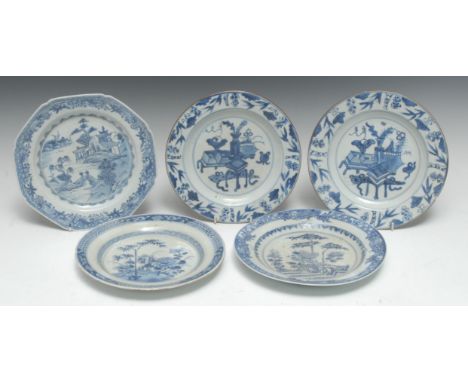 A pair of Chinese circular plates, decorated with vases, low tables, foliage and precious objects, the border with bamboo, 22