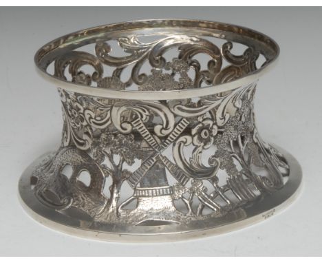 An Edwardian Irish silver dish ring, of typical reel shaped form, pierced and chased in the 18th century taste with a castle,