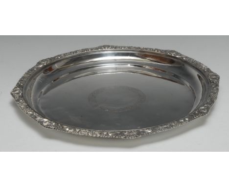 A China Trade period Chinese silver shaped circular salver, shell, stiff leaf and fruiting vine border, the plain field chase