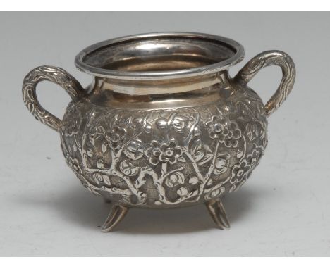 A Chinese silver two-handled cauldron shaped bowl, profusely chased with blossoming prunus, 9.5cm wide, Wang Hing &amp; Co, c