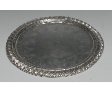 An 18th century Portuguese silver circular salver, gadrooned border, the field chased with a band of leafy strapwork, 31.5cm 