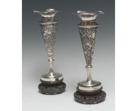 A pair of Chinese silver trumpet shaped mantel vases, pierced and embossed with blossoming prunus, wavy everted rims, carved 