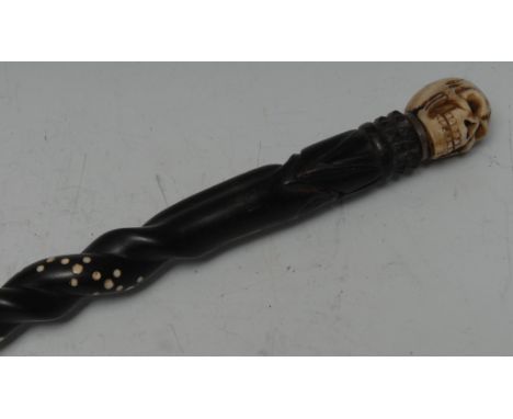 A bone 'momento mori' walking stick handle, carved as a skull, associated Anglo-Indian shaft, 84cm long
