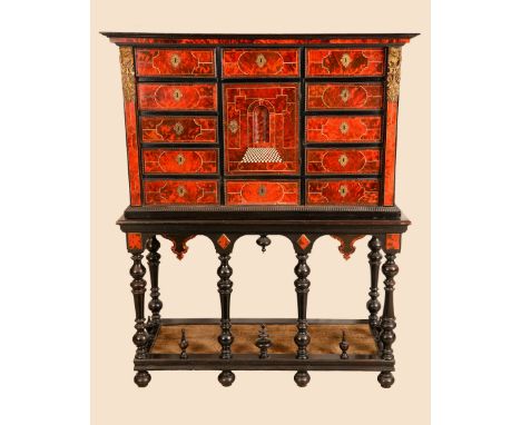 A 17th century Flemish tortoiseshell, ebony and marquetry cabinet on stand, moulded cornice above a rectangular cupboard and 