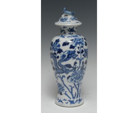 A Chinese porcelain baluster vase and cover, painted in underglaze blue with ferocious dragons and peonies, outswept domed co