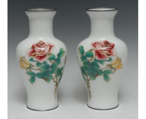 A pair of Japanese cloisonné enamel baluster vases, decorated in polychrome enamels with pink and yellow roses on a white gro