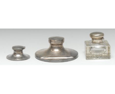 A large George V silver capstan inkwell, hinged cover, pen rest to base, 16.5cm diam, William Neale, Birmingham 1930; other s