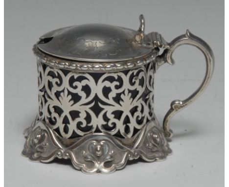 A Victorian Rococo Revival silver mustard, hinged domed cover with shell thumbpiece, pierced and engraved with scrolling leav