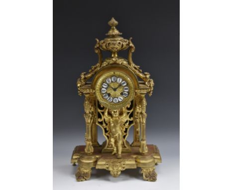 A 19th century French gilt-metal mantel clock, 9cm circular dial applied with enamel cartouches inscribed with Roman numerals