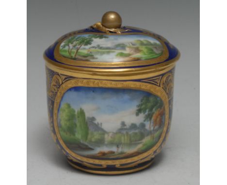 An 18th century  Sèvres sucrier and cover, decorated with landscape within an oval cartouche, on a cobalt blue ground with gi