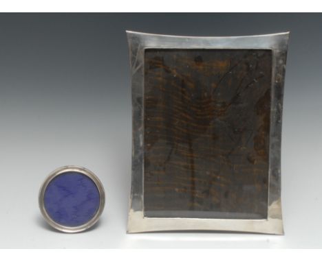 A large George V silver incurved rectangular easel photograph frame, quite plain, 31cm high, marks rubbed, c.1920; another, c