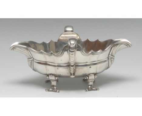 A Continental silver shaped oval double-lipped sauceboat, scroll-capped handles, scroll feet, 19.5cm wide, marks struck four 