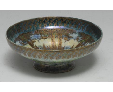 A Royal Worcester Crown Ware lustre pedestal ogee bowl, printed and painted with tall trees in a mottled green, yellow and bl