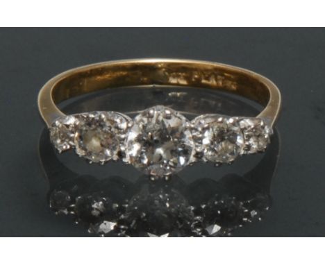 A quintet diamond ring, linear inset with five graduated old brilliant cut diamonds, largest central diamond approx 0.50ct, t