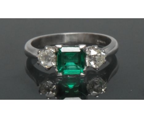 A Columbian emerald and diamond trilogy ring, central square cushion cut vibrant green emerald, approx 0.64ct, flanked either