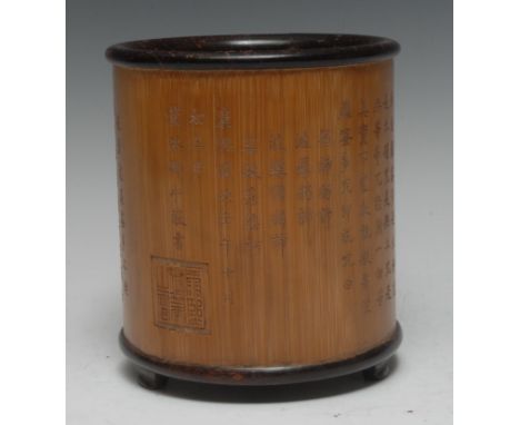 A Chinese two-tone bamboo bitong brush pot, profusely carved in shallow relief with script, bracket feet, 15.5cm, six-charact