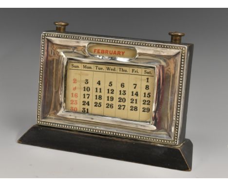 A George V silver desk calendar, rectangular aperture, ebonised base, 15cm wide, Birmingham 1931