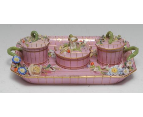 A Minton canted rectangular standish, with two 'coopered' pail inkwells and central taper stick, in pink picked out in gilt, 