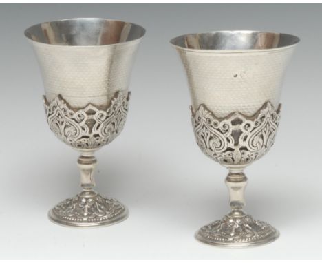 A pair of 19th century Turkish silver wine goblets, the flared bowls engine turned, the heavy bases and socles cast with leaf