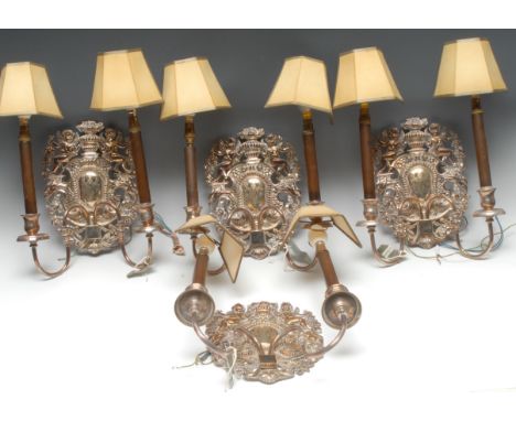 A set four Baroque style silver plated two-light-two branch wall lights, the back plates pierced and embossed with cherubs fl