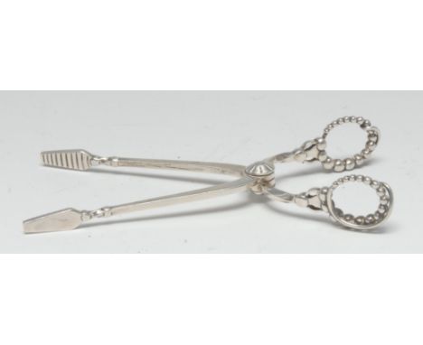 A pair of Georg Jensen sugar nips, beaded ring handles, marked Georg Jensen in an oval, Sterling Denmark