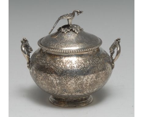 A Turkish silver sucrier and cover, chased with townscape vignettes and dense scrolling foliage, bird finial, acanthus scroll