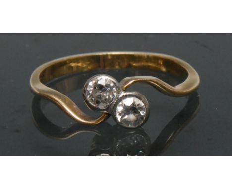 A diamond crossover twist ring, inset with two old brilliant cut diamonds, each approx 0.15ct,total estimated diamond weight 