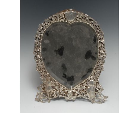 A Victorian silver heart shaped easel dressing table mirror, pierced and embossed with crusading knights and scrolling foliag