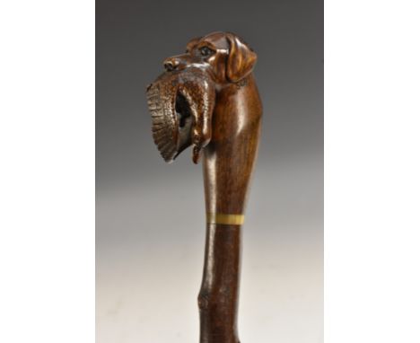 A carved blackthorn walking stick, retriever with duck, soft cloth case, marked SCR