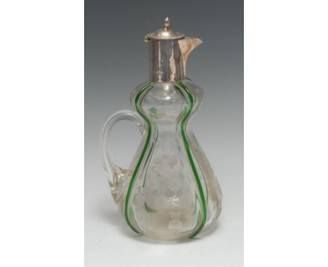 An Art Nouveau period silver mounted claret jug, hinged cover with laurel border, the double-gourd body cut with Scottish thi