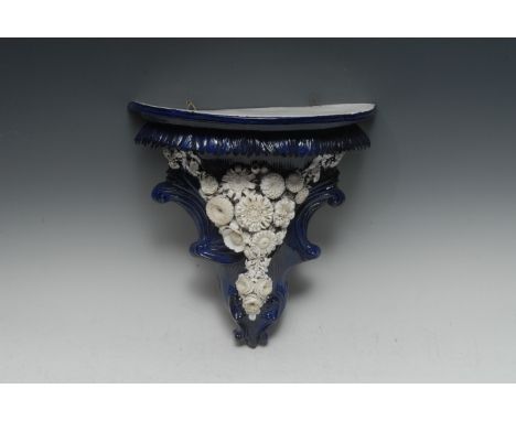 A Sampson Hancock Derby cartouche-shaped wall bracket, in the Rococo Revival taste, applied with a Blanc de Chine ribbon-tied