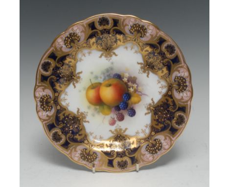 A Royal Worcester shaped circular plate, painted by Albert Shuck, signed, with ripe apples and blackberries, within fancy gil