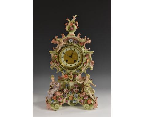 A German Rococo Revival porcelain clock, probably Sitzendorf, 10cm ivorine chapter ring inscribed with Arabic numerals, twin-