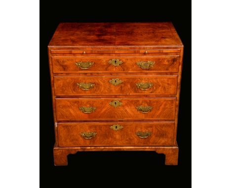 A George I walnut caddy top bachelors chest, quarter-veneered crossbanded top with moulded edge above a slide and four long g