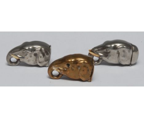An early 20th century novelty plated vesta, as an elephant, trunk curled, 16cm wide, c.1910; another; others, brass (3)