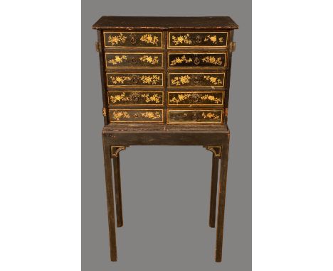 A 19th century Japanned cabinet on stand, oversailing top above two rows of five collector's drawers, each decorated in gilt,