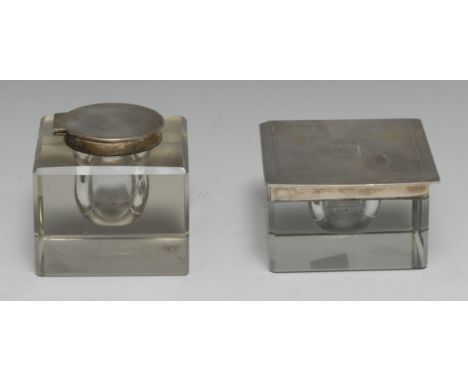 A George V silver mounted clear glass square inkwell, hinged engine turned cover, 10cm wide, Birmingham 1930; another, London