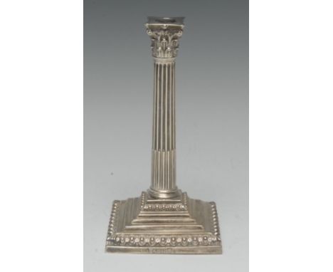 A George III silver stop-fluted Corinthian column taper stick, stepped square base, ovolo borders, 17.5cm high, Thomas Shephe