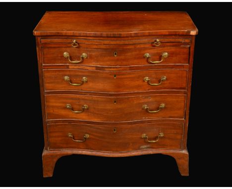 A George III mahogany serpentine bachelors chest, slightly oversailing top outlined with boxwood stringing, above a slide and