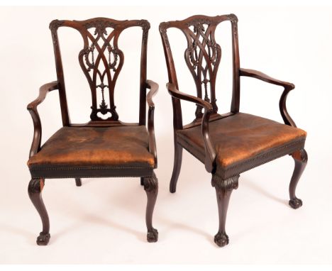 A pair of Chippendale Revival mahogany elbow chairs, cupid's bow cresting rails and shaped and pierced splats carved with scr